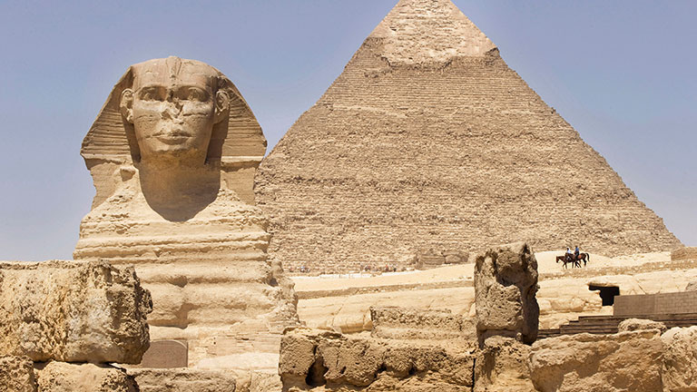 The Great Sphinx and Pyramid of Giza under a clear blue sky in Egypt