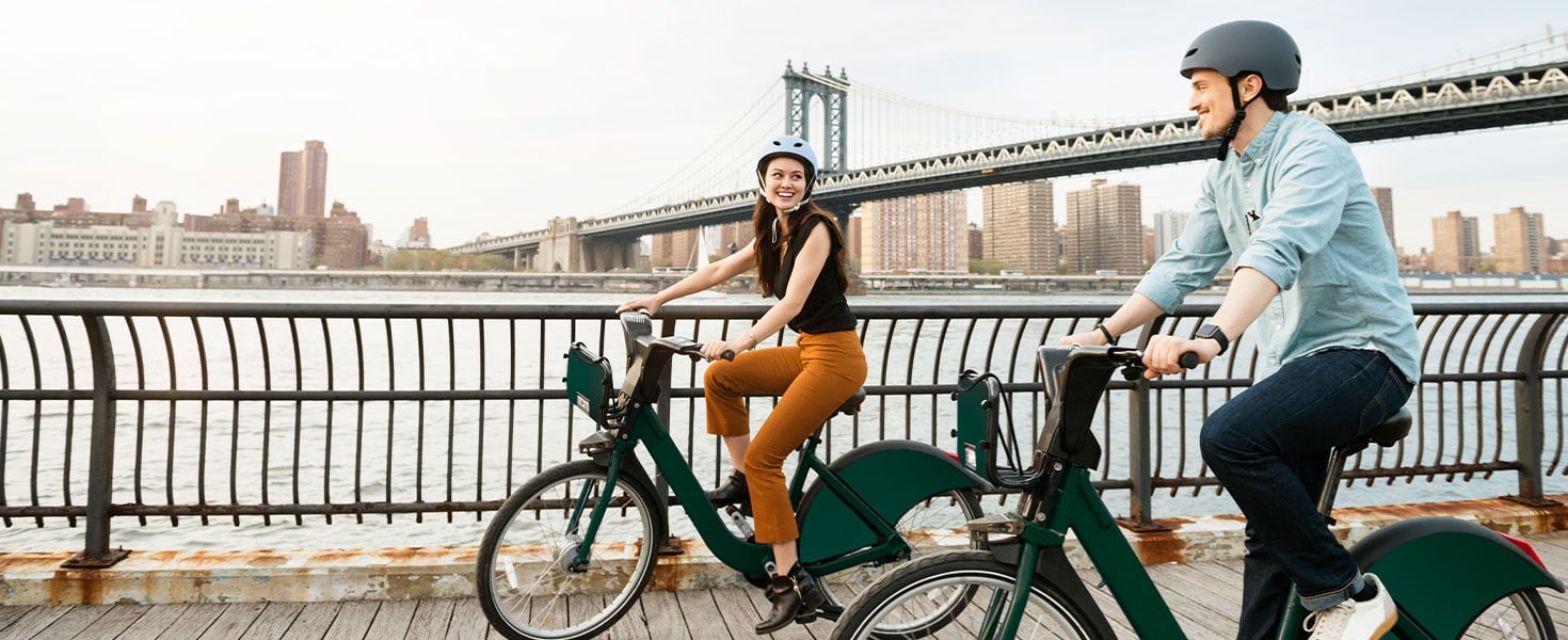 people biking near city bridge 