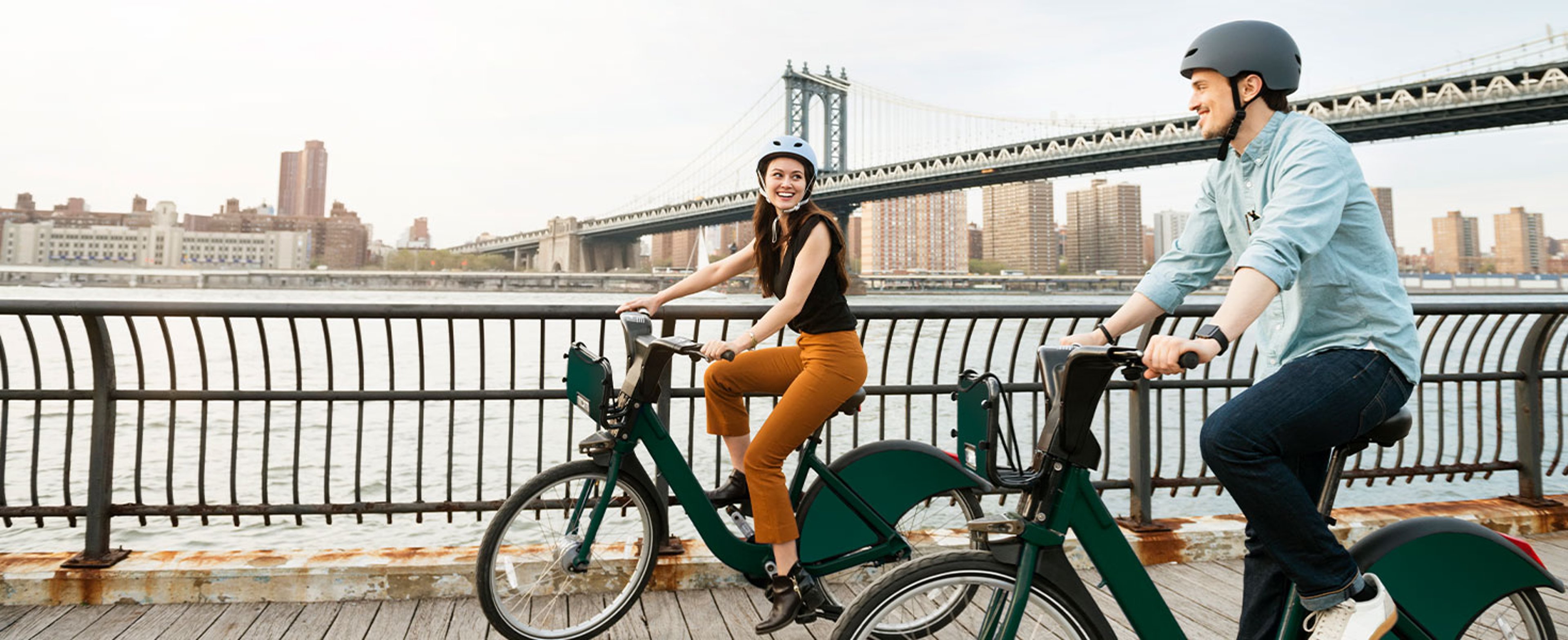 people biking near city bridge