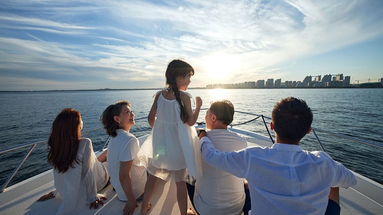 Happy family aboard a yacht out to sea. Credit: chinaview