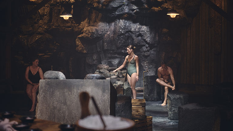 Guests relax in the Skjól Ritual sauna experience at Sky Lagoon in Iceland.