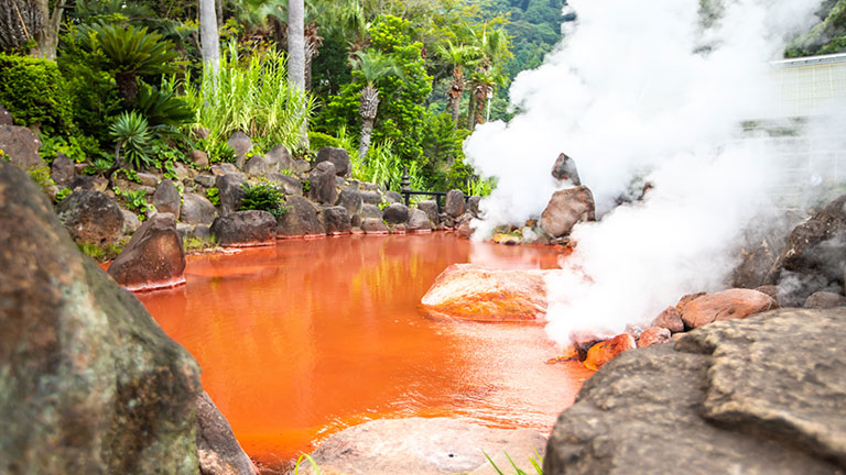 Steam rises from Umi Jigoku (Sea Hell), a geothermal hot spring in Beppu, Japan.