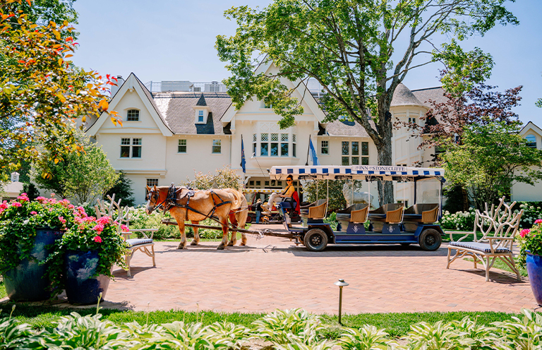 Horse Drawn carriage in front of Inn at Stonecliffe on Mackinac Island