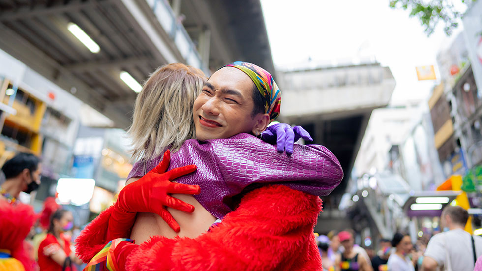 Happy couple having fun in the street LGBTQ pride parade