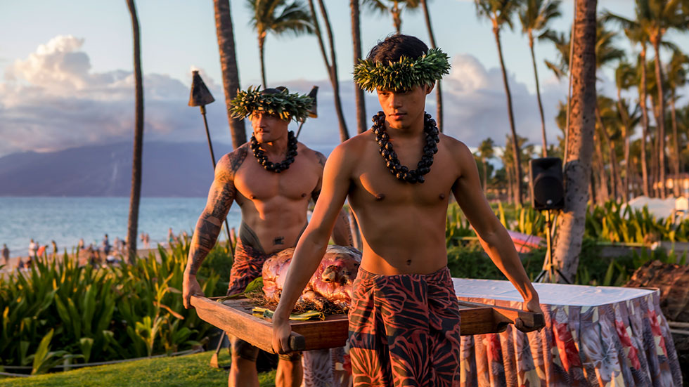 Hawaiian carrying roasted pig