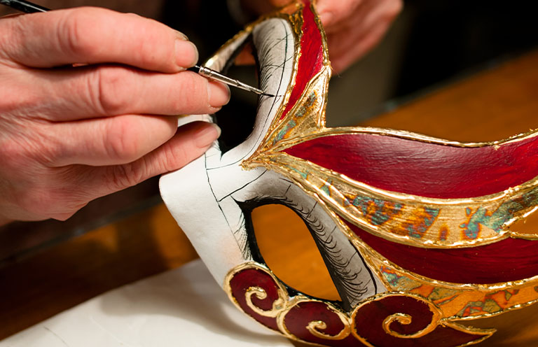 woman making a venice carnival mask