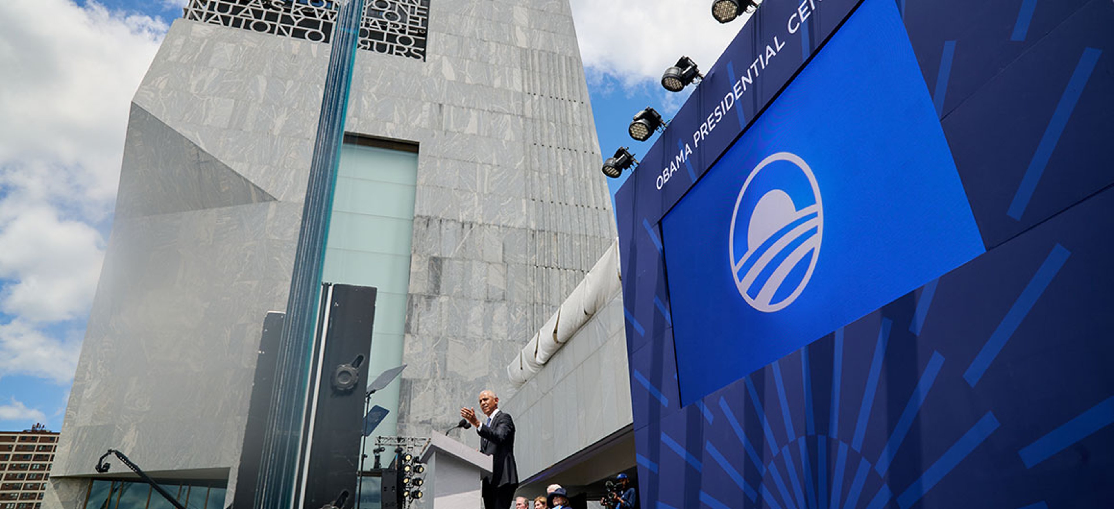 Barack Obama standing outside the Obama Presidential Center museum in Chicago.