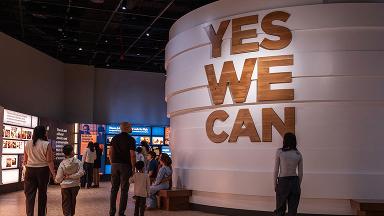 Visitors explore interactive exhibits inside the Obama Presidential Center museum.