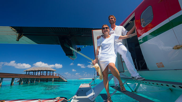 luxury travel couple arriving on tropical island with seaplane Credit:amriphoto