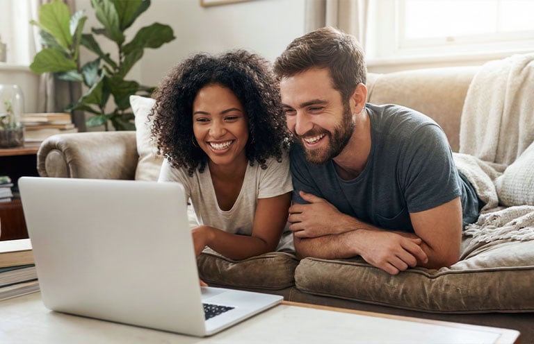 man and woman looking at laptop