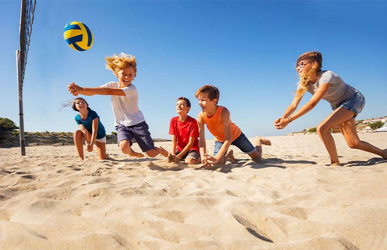 kids playing beach volleyball