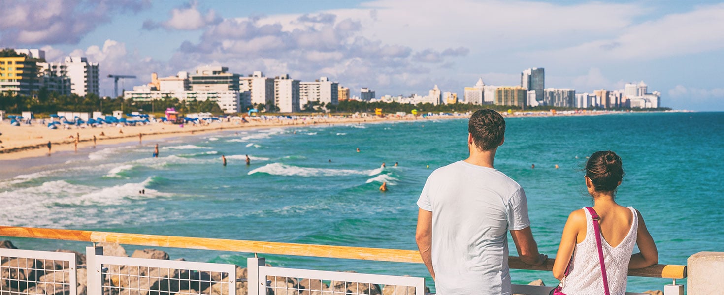 Couple looking at Miami from pier