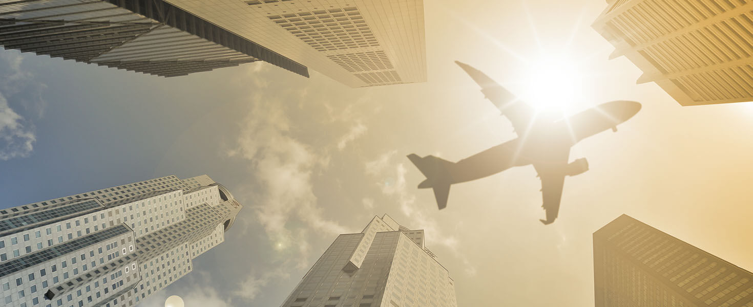 Plane flying over a city