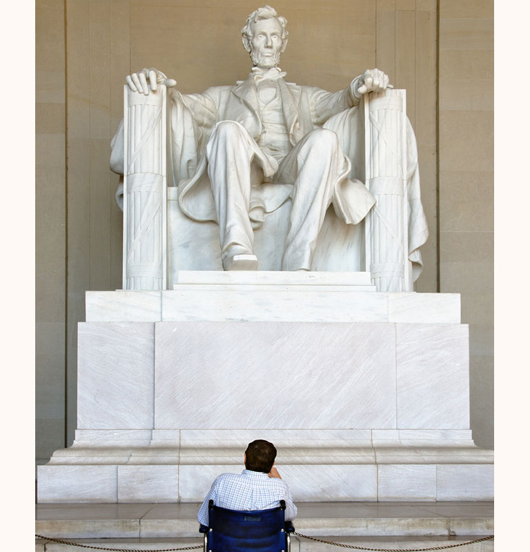 Man in wheelchair looking at Lincoln Memorial