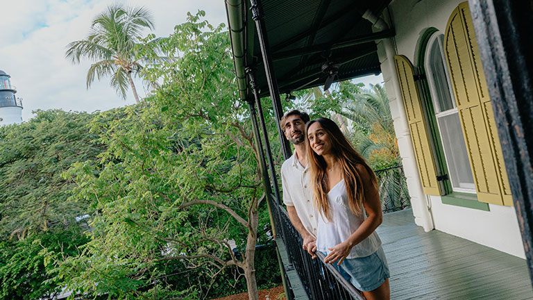 Visitors standing on the balcony of the Ernest Hemingway Home in Key West.