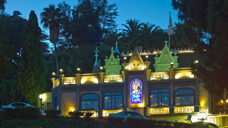 The Magic Castle, home of the Academy of Magical Arts, illuminated at dusk in Los Angeles.