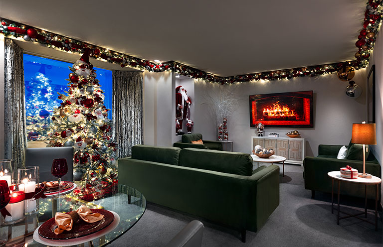 christmas themed room, lights, tree, decorations, fireplace