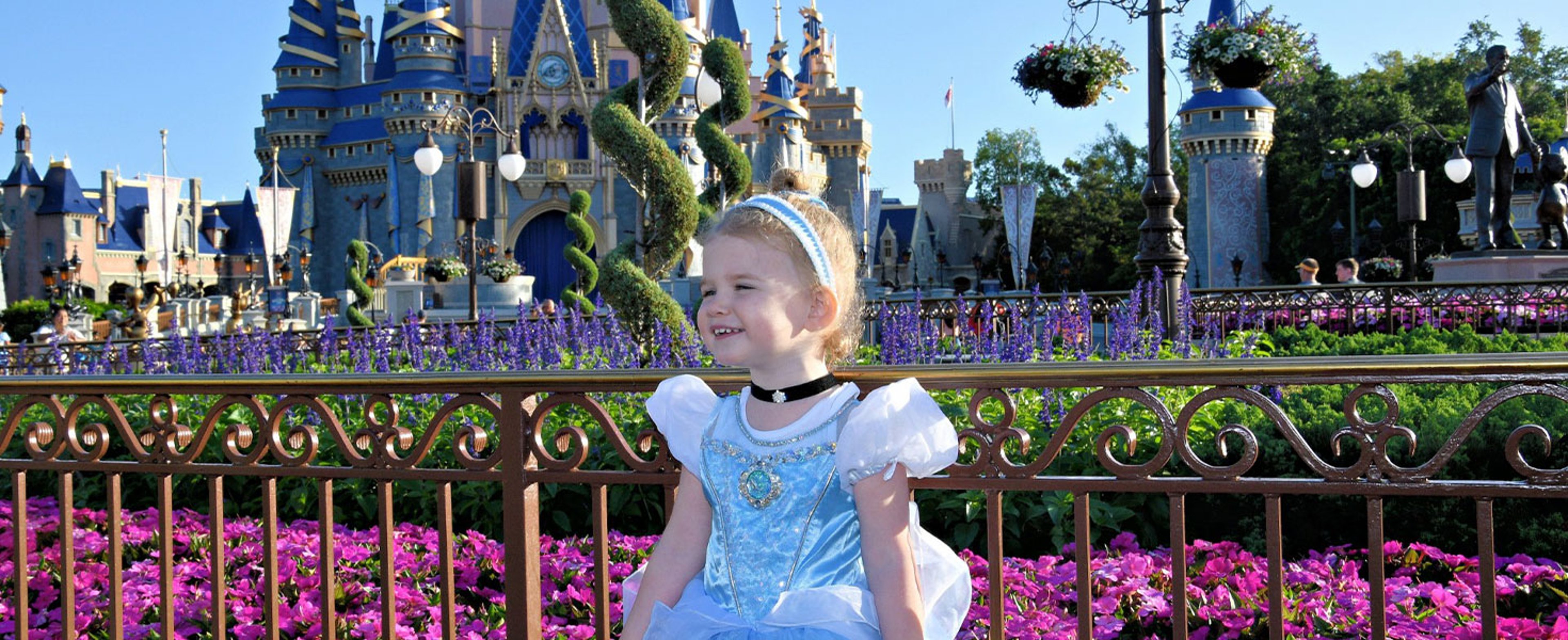 Little girl in cinderella costume in front of Disney's Magic Kingdom castle