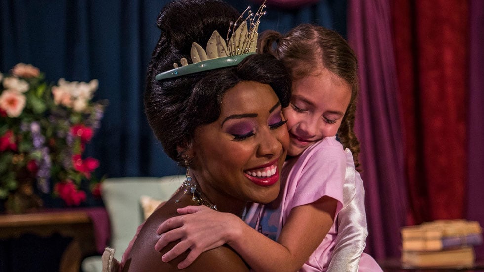 Princess Tiana hugging little girl