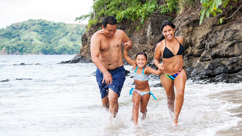 Family running on a beach