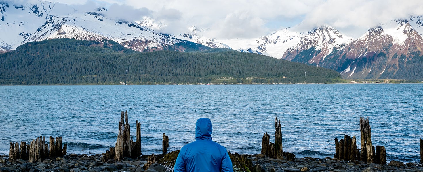 Man looking fjord and mountain