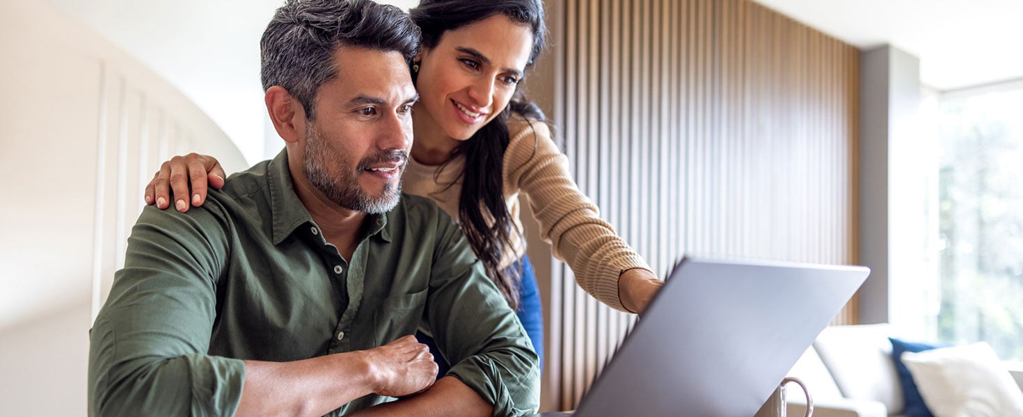 Loving couple organizing their home finances and looking at bank statements while using their laptop - financial planning concepts Credit:Hispanolistic