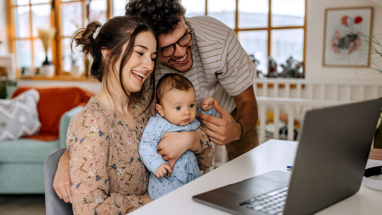Businesswomen Analyzing Sales Data on Laptop in Office