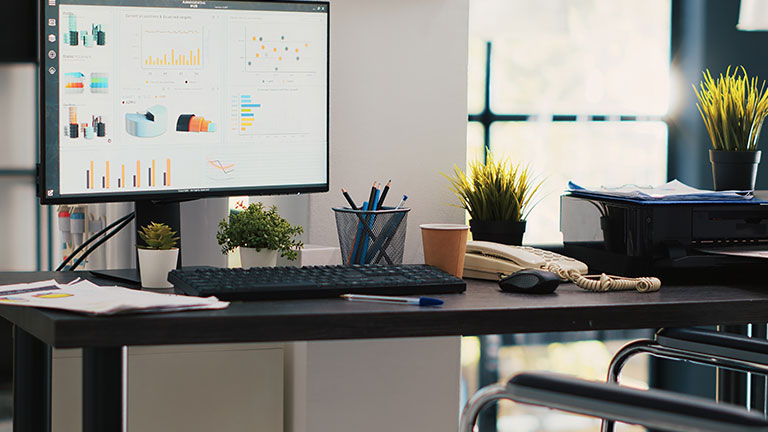 Wheelchair in inclusive office and display showing marketing planning data 