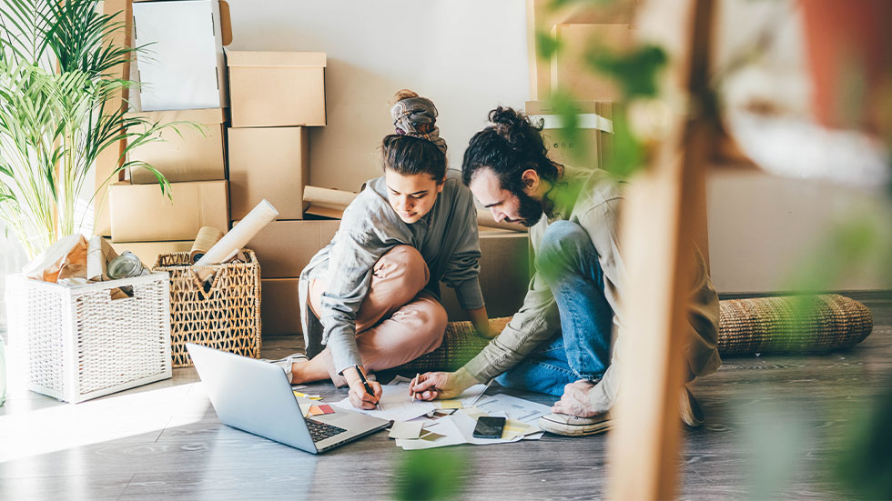 couple using laptop in apartment