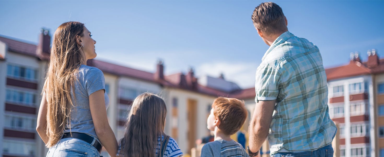 family looking at apartment building