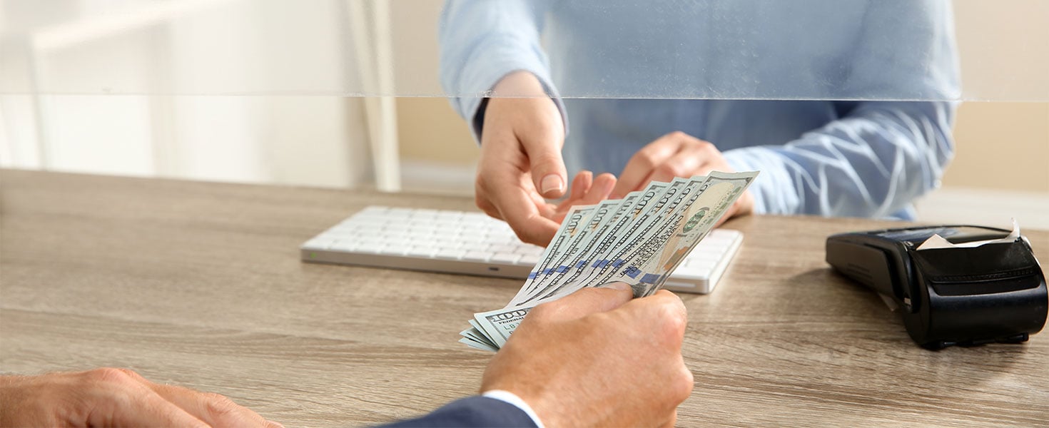 Customer giving teller cash