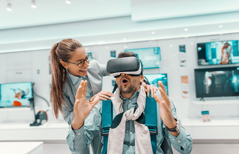 woman showing man vr headset