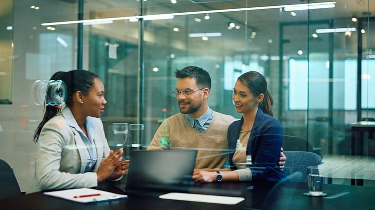 couple sitting with woman in office