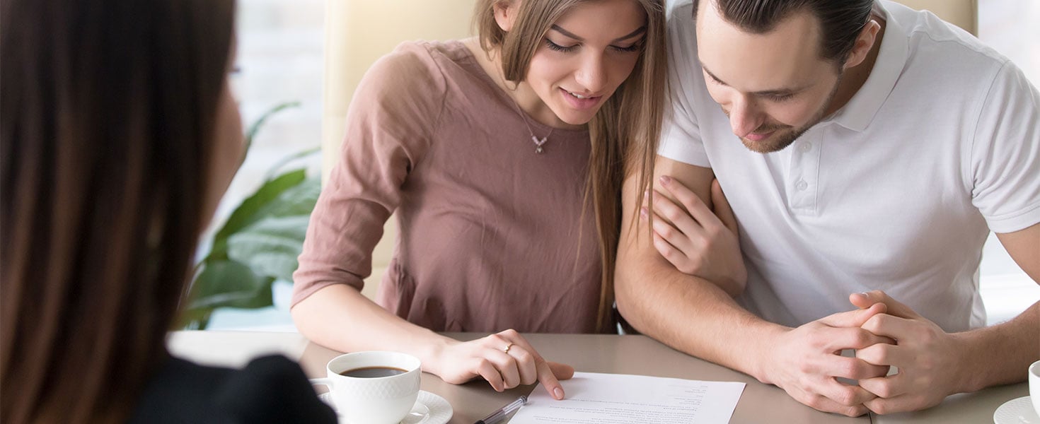 man and woman looking at document