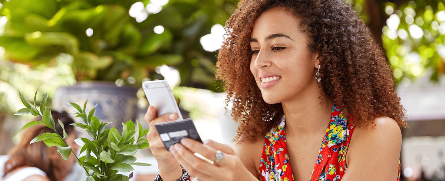 woman holding phone and credit card