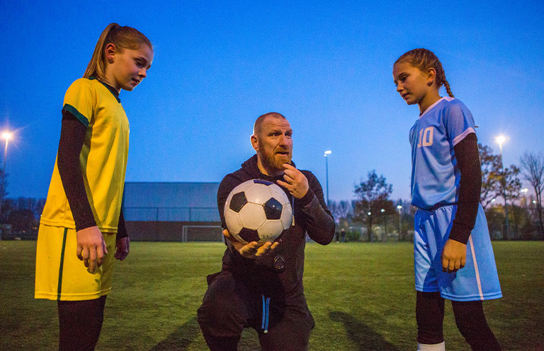 soccer coach during ball toss