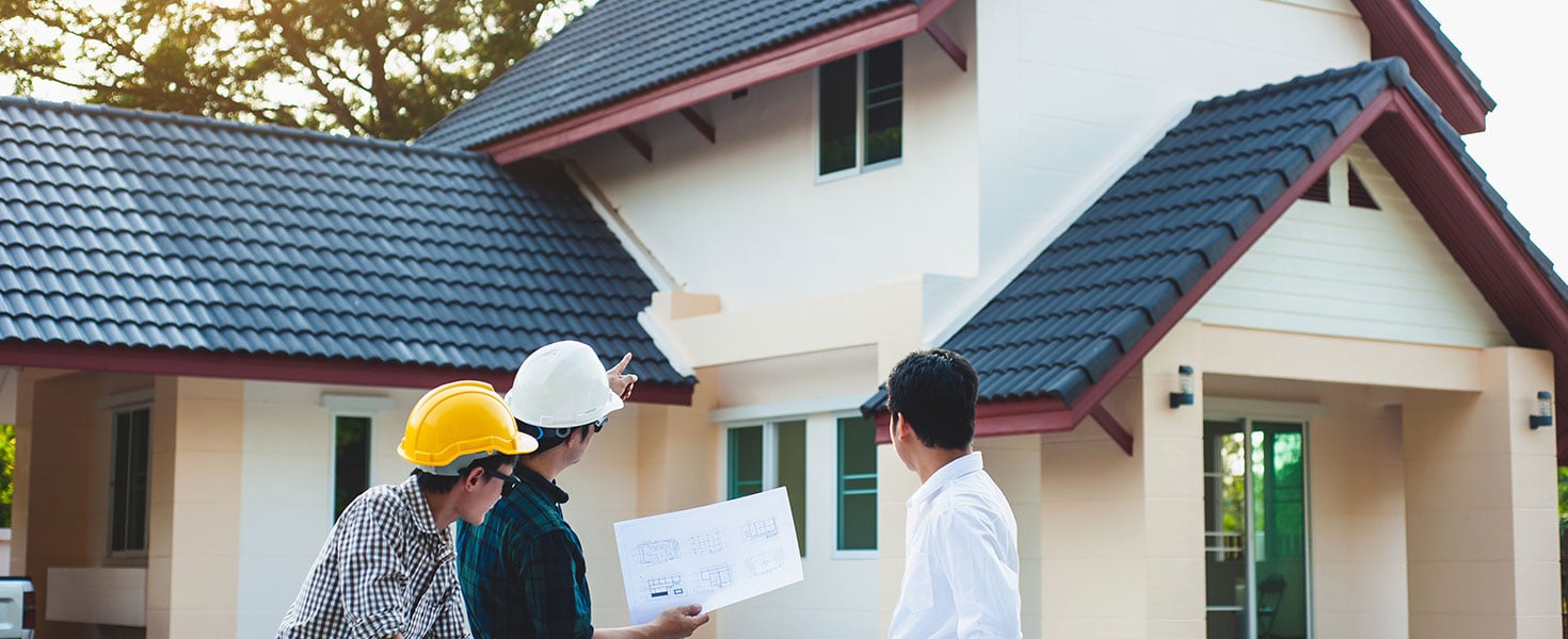 Structural inspector engineers are reviewing the building project. The architects are discussing and planning the renovation of the house. By Wasan