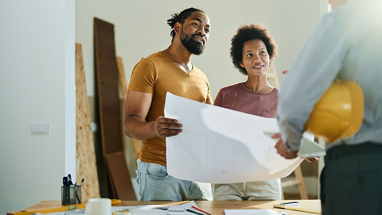 Happy black couple talking to real estate agent in the apartment
