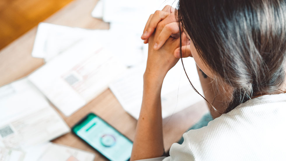 Girl using phone, holding credit card