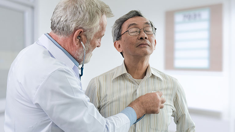 The senior doctor listen the heart of the elderly patient By pixs4u