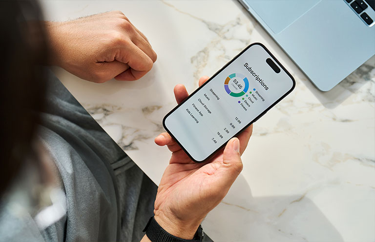 man looking at subscription budget tracker