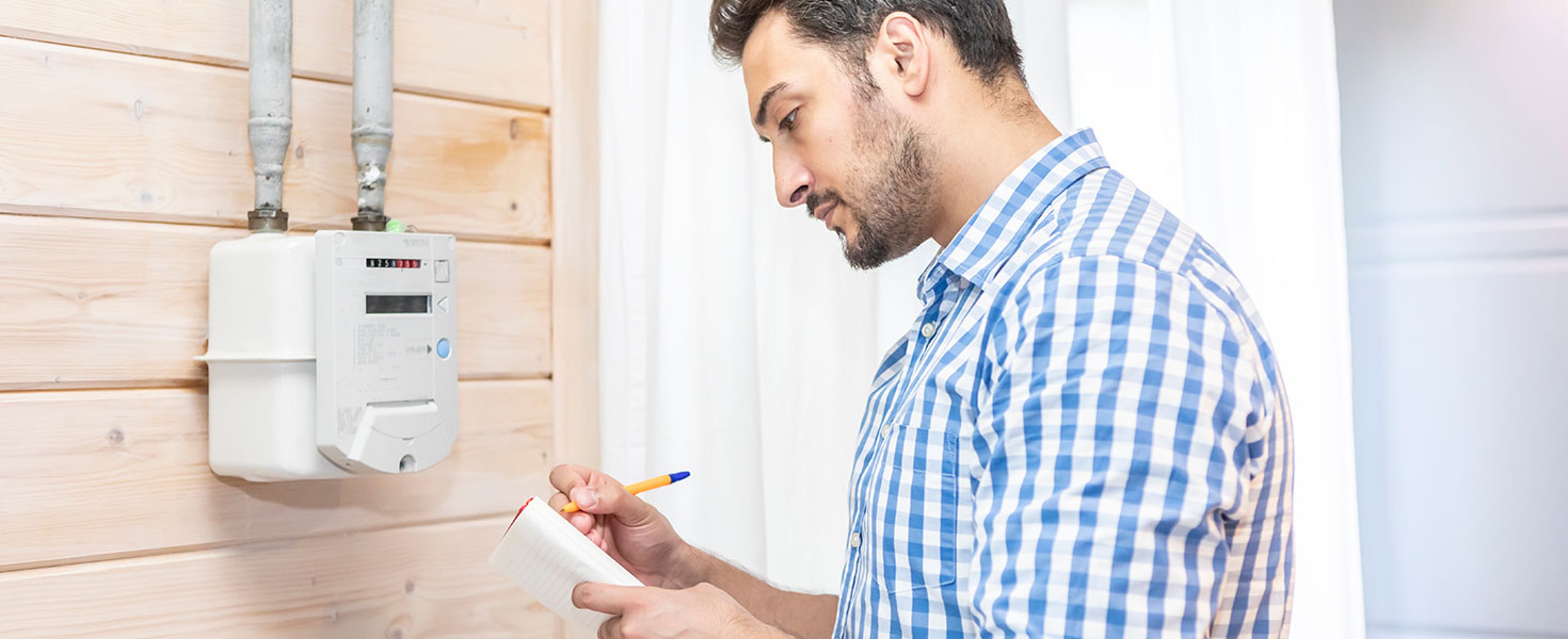 A worried man takes readings from his gas meter and tries to identify the problem during the energy crisis. By Vitaliy