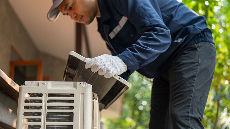 Air conditioner service outdoor checking fix repair. Air conditioner cleaning technician He opened the front cover and took out the filters and washed it. He in uniform wearing rubber. Credit:chanakon laorob
