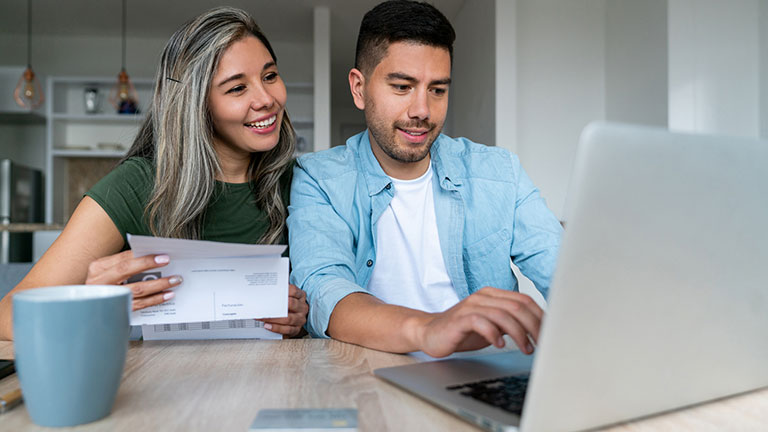 couple at home paying bills