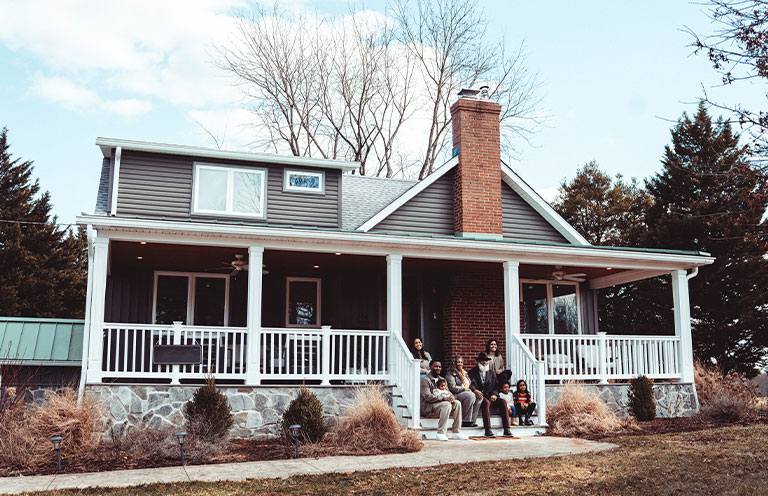 family sitting on front porch
