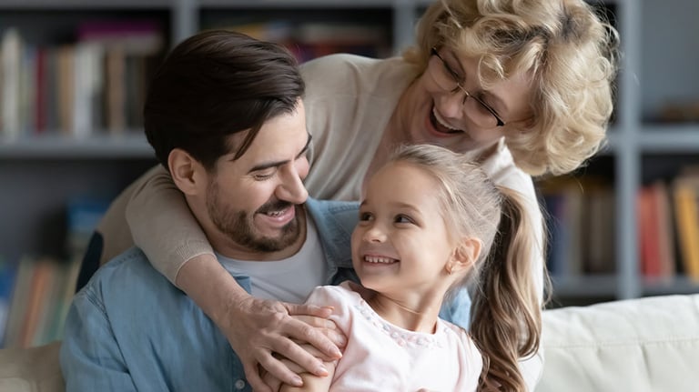 grandparent, parent, and child hugging