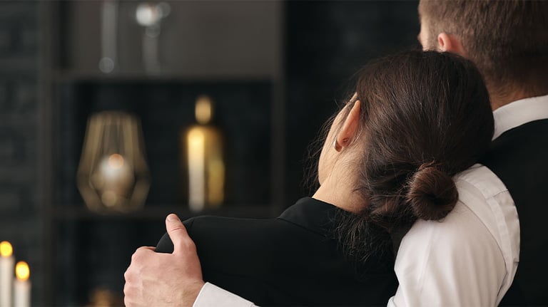 man and woman at funeral