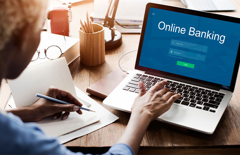 woman logging into online banking on laptop