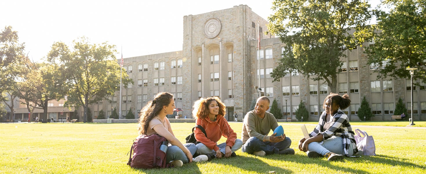 college students sitting on lawn