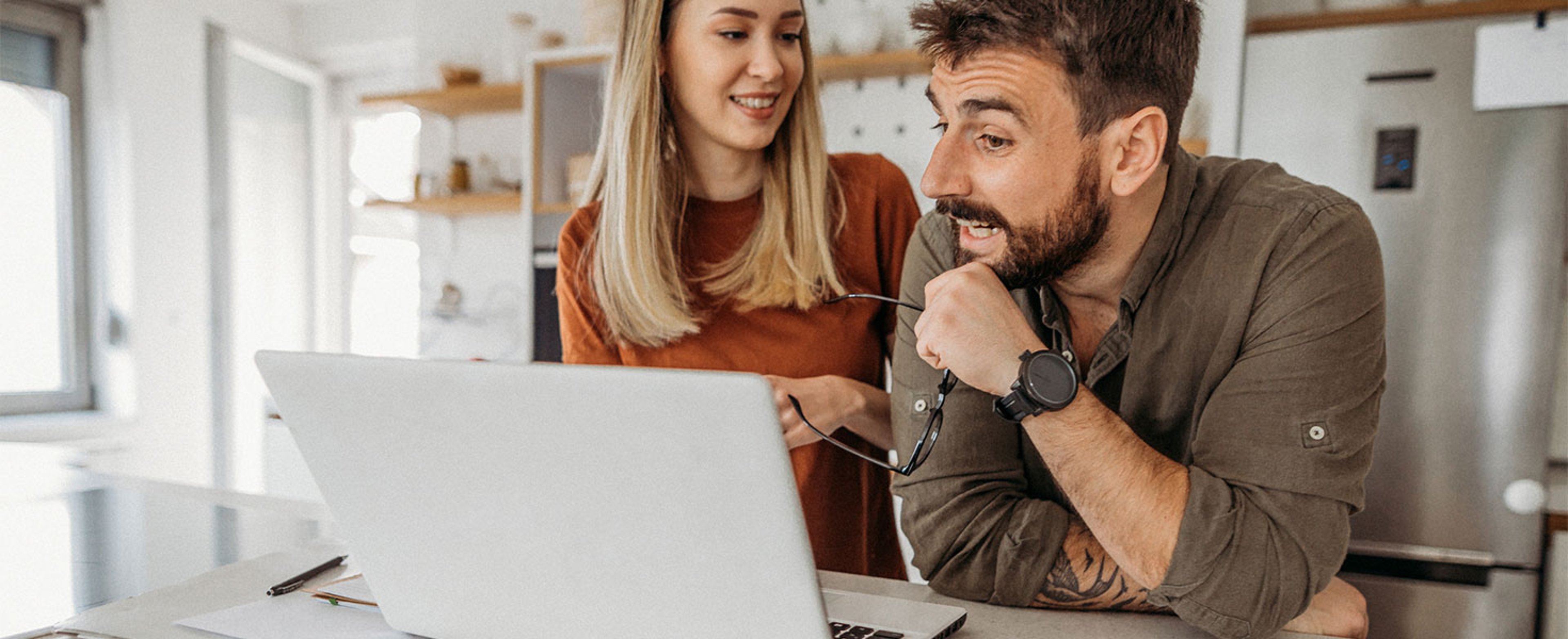 man and woman looking at laptop